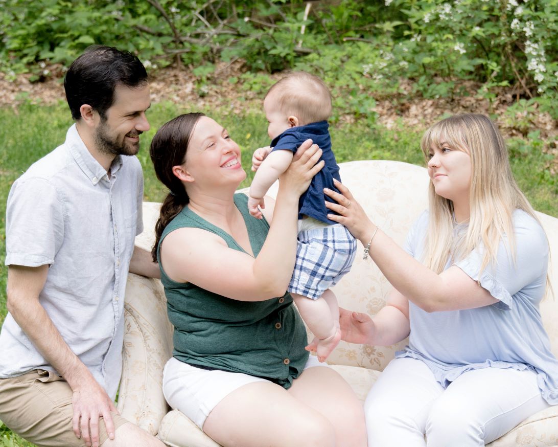 Adoptive mom smillig at baby