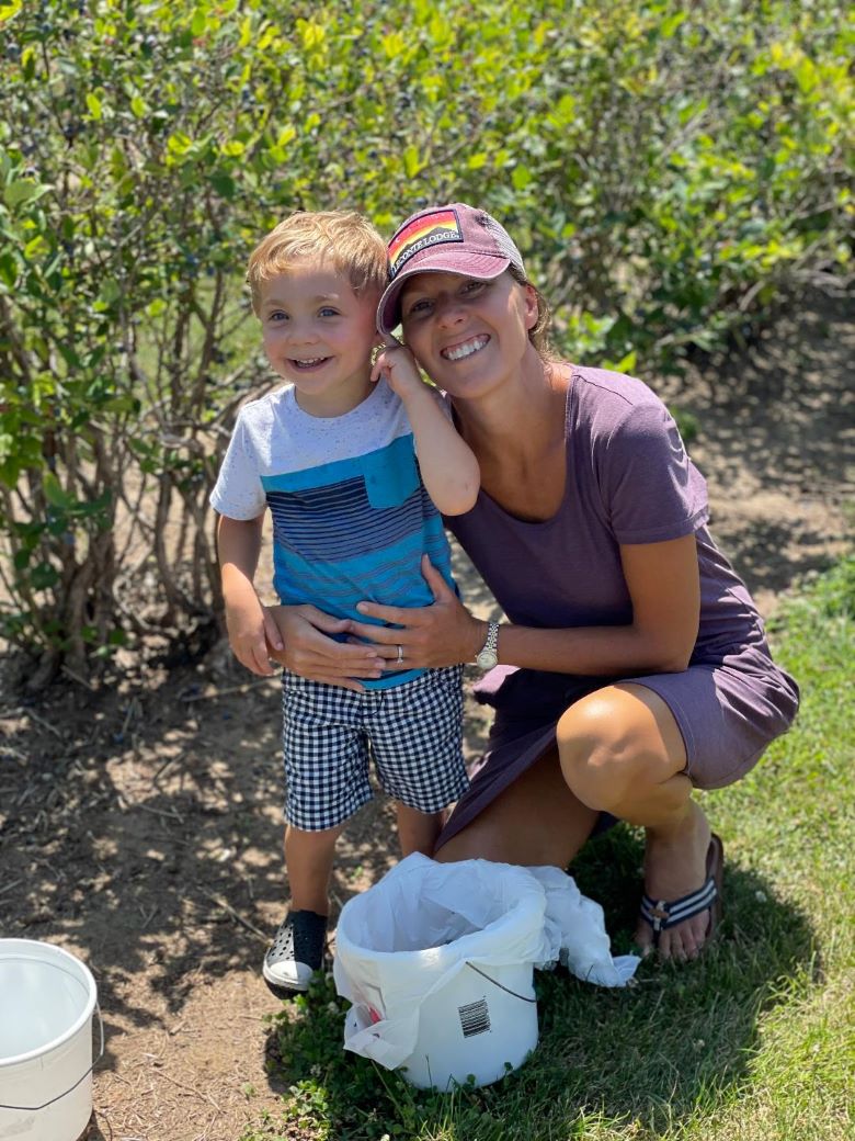 Kristine and child at a u-pick farm