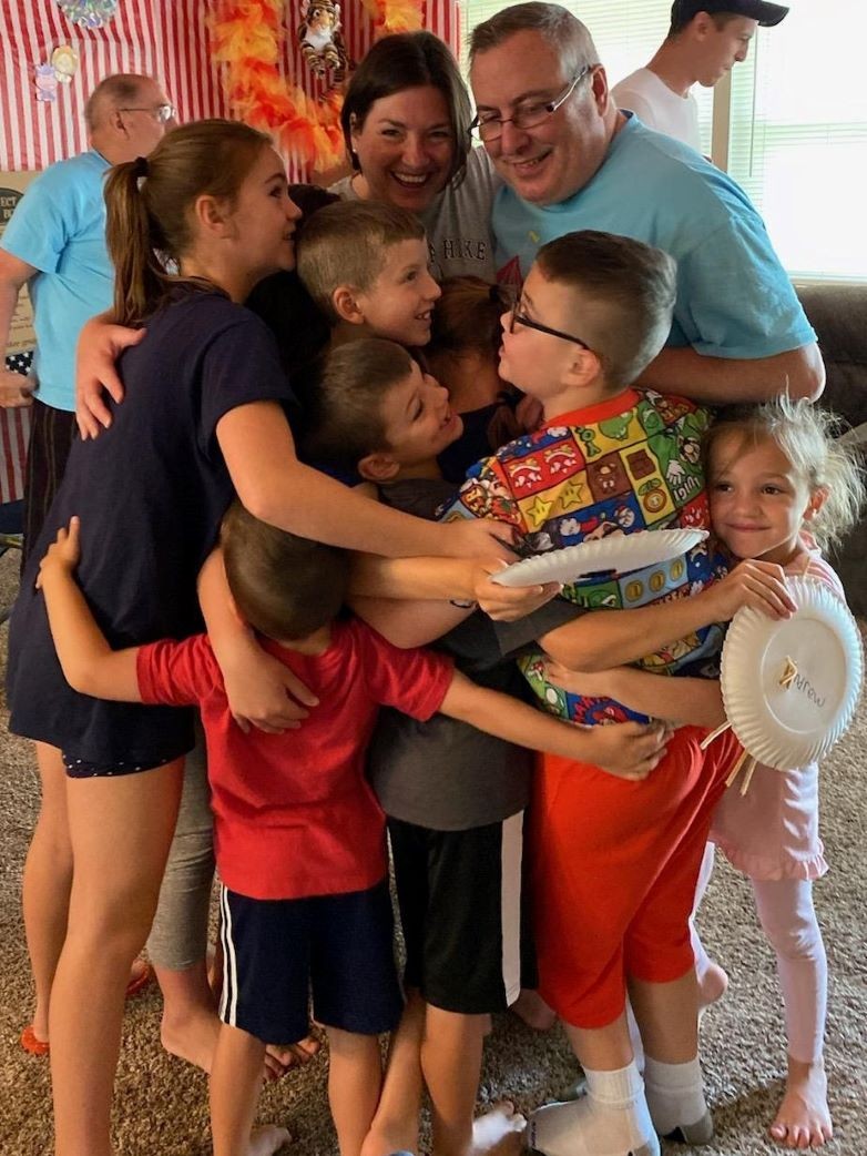 Bonnie and Lloyd with children in a big group hug