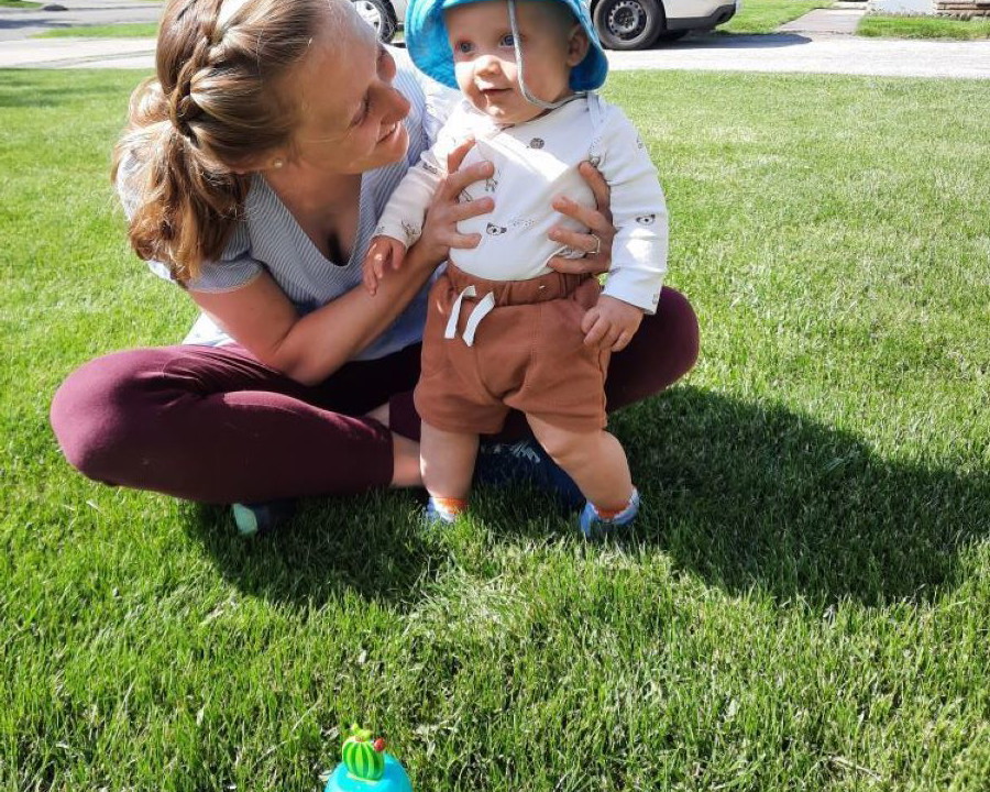 Emily with her son in the grass.  Excited and ready to welcome another child into their family through adoption in Ohio