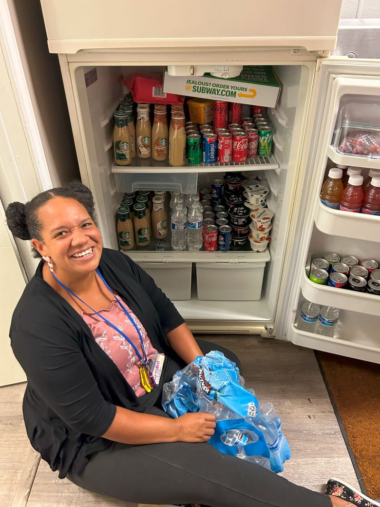 Volunteer stocking fridge with drinks