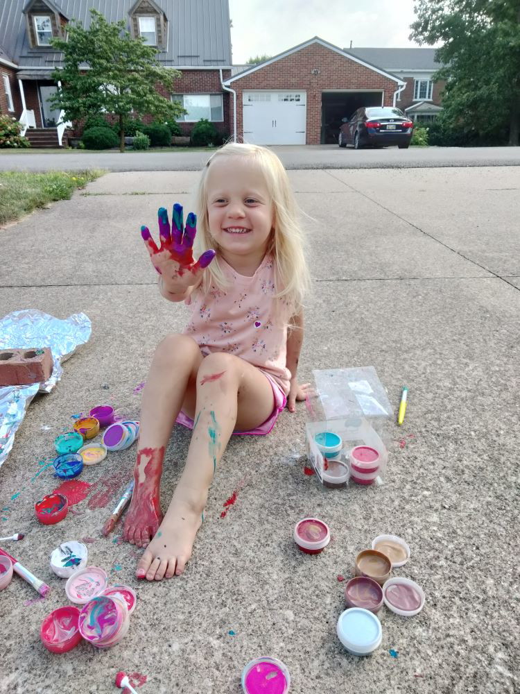 Kevin and Emily's daughter, excited to welcome an adopted sibling into her family