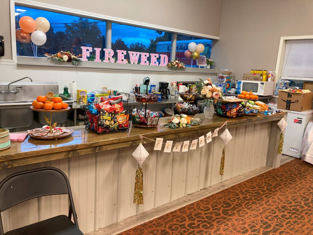 Food setup with decorative fireweed sign