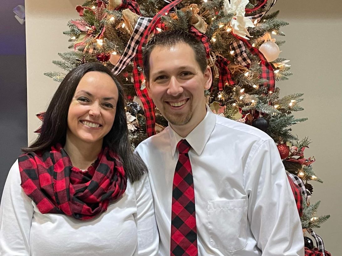 Jonathan and Tara in front of a Christmas tree