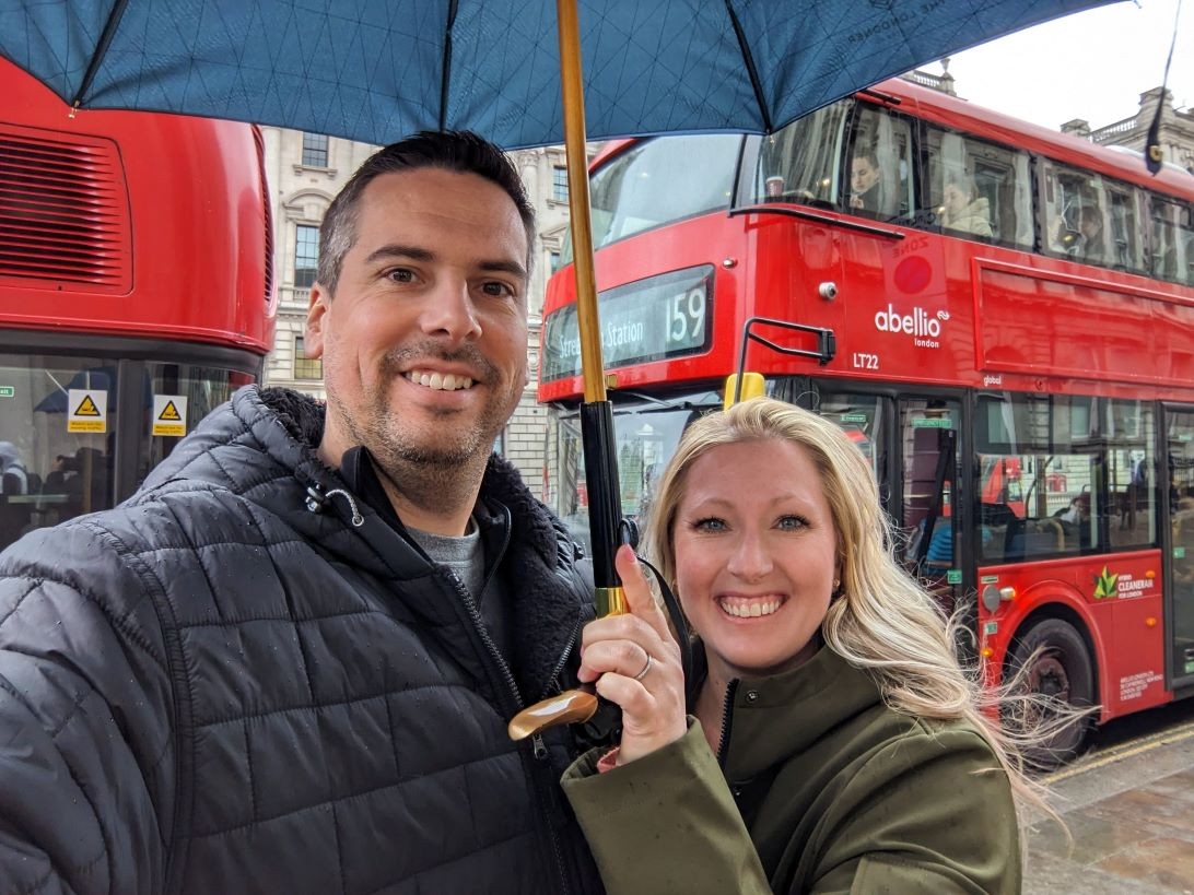 Pete and Tiff by double decker buses