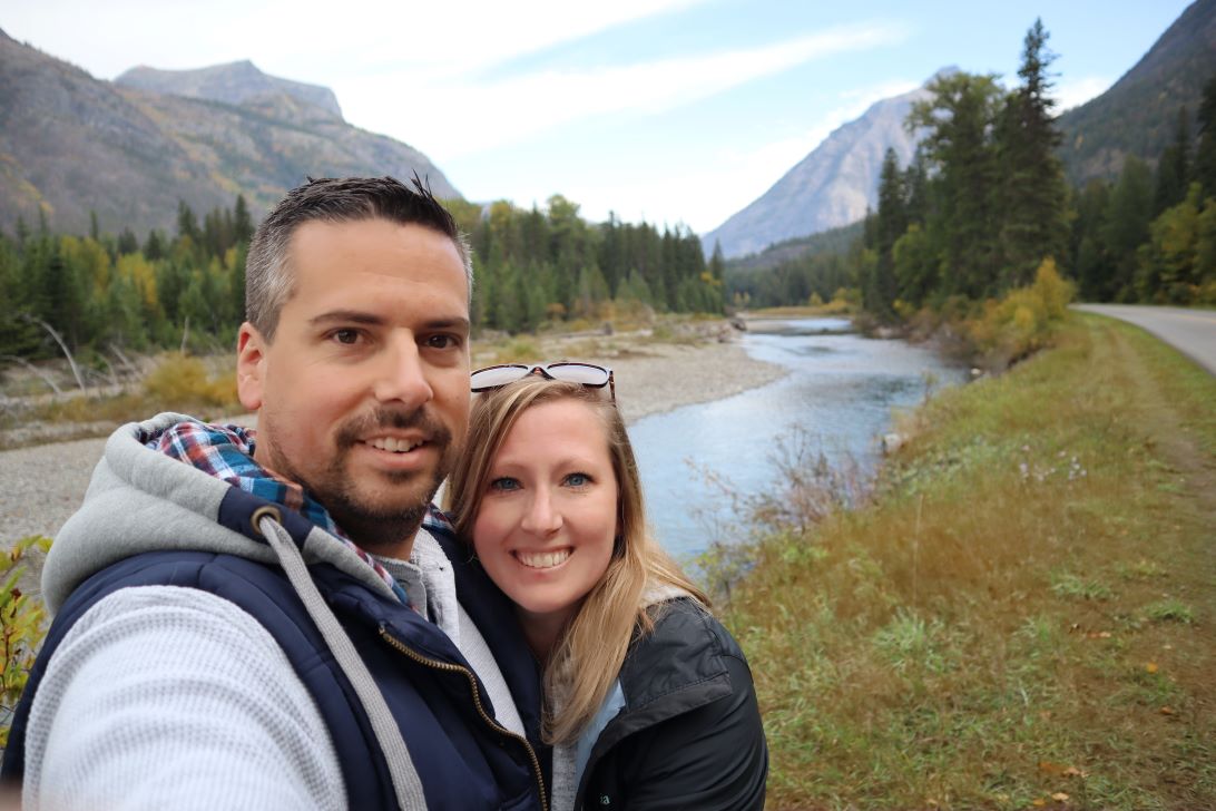 Pete and Tiff with a river and mountains in the background