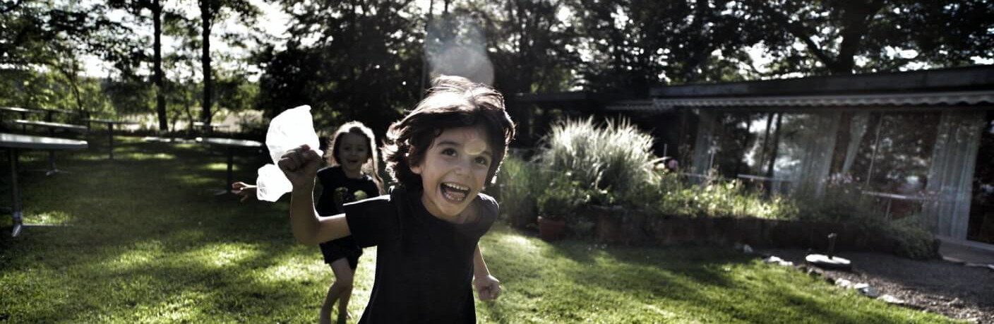 Children running in a front yard