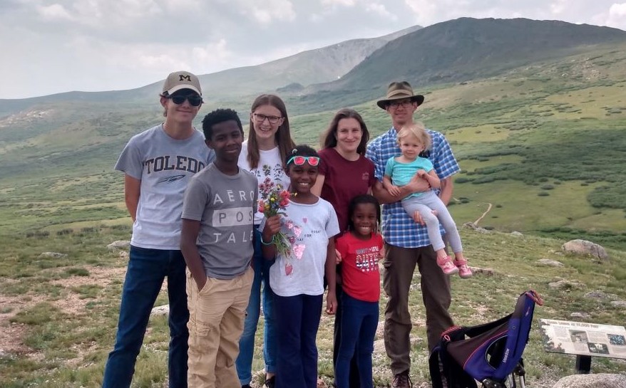 Family with adopted children on a hiking trip